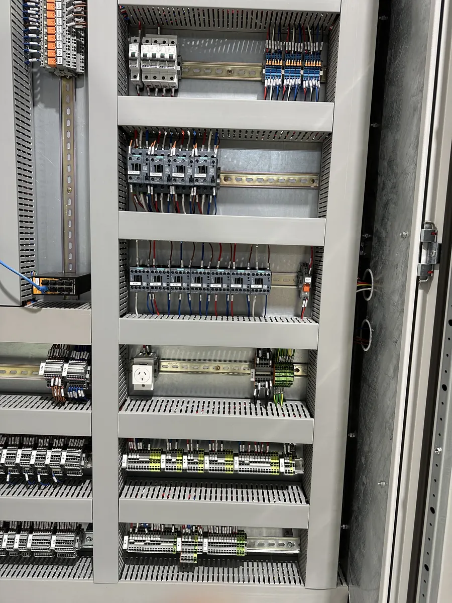 Detailed wiring and control components inside an electrical control panel