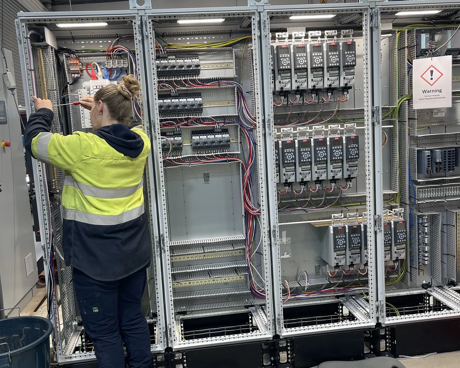 Electrical site support work inside an industrial control cabinet